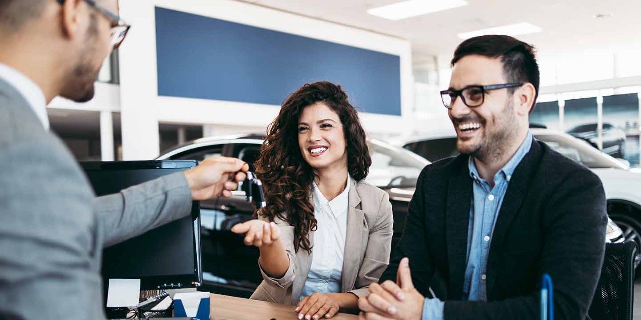 Young couple taking a new car key