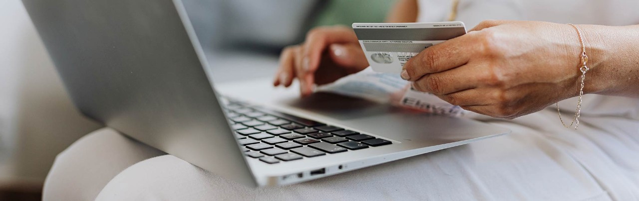 close up hand using credit card and laptop