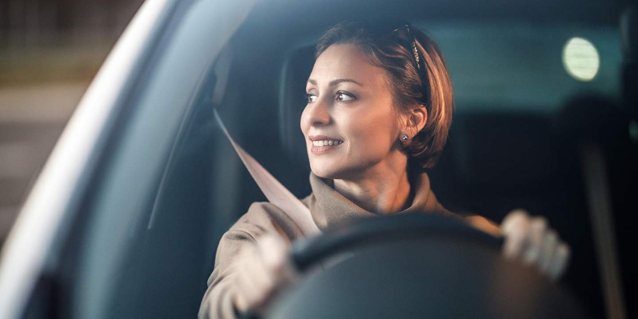 smiling woman driving car