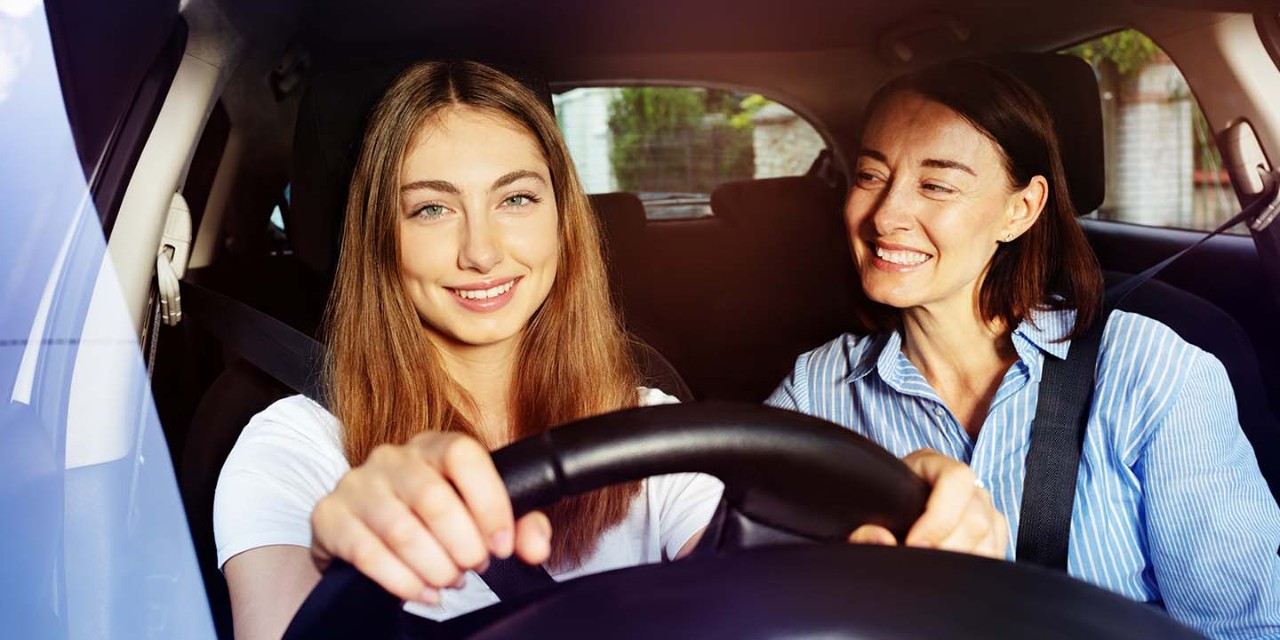  Girl and her mother during driving lesson in a car