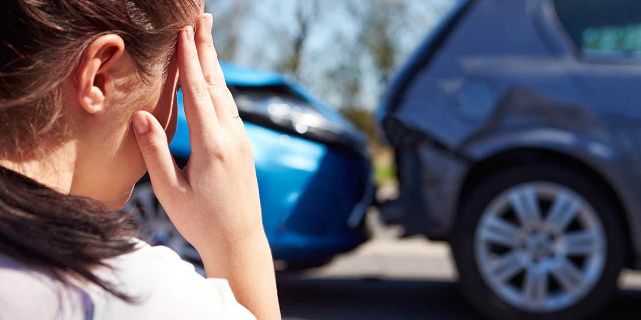 Stressed Driver Sitting at Roadside after Traffic Accident 
