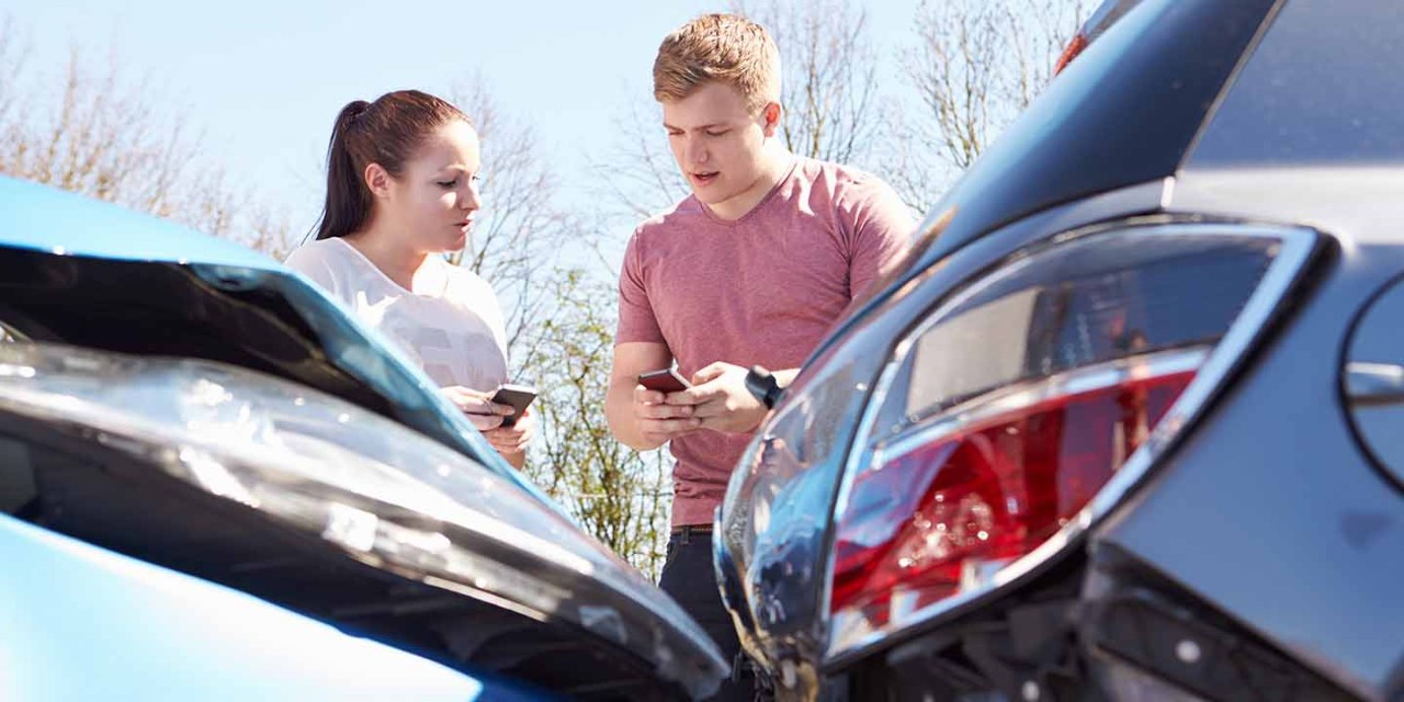 Two Drivers Exchange Insurance Details After Car Accident