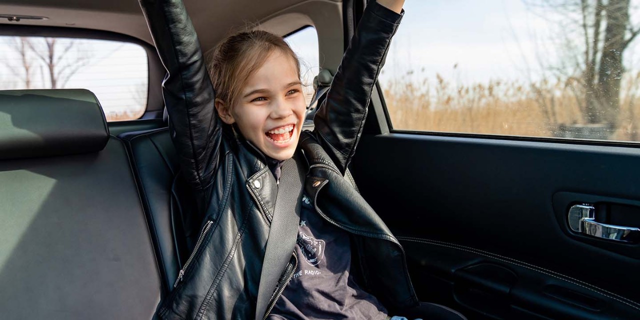 smiling girl on the car