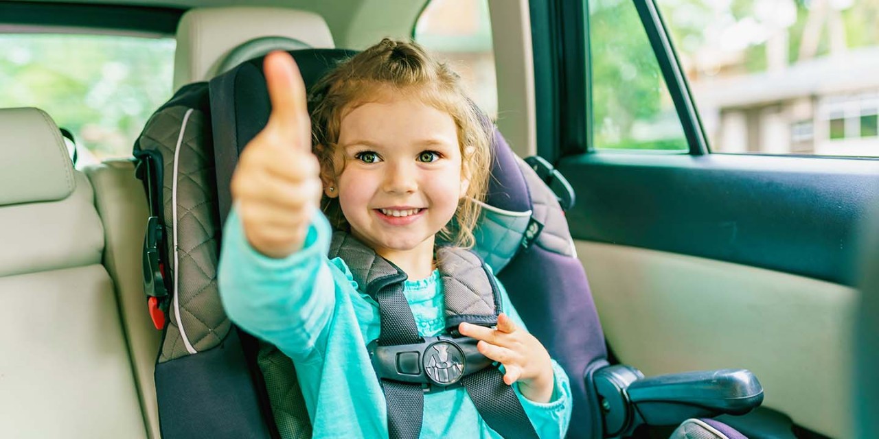 smiling girl on the car seat