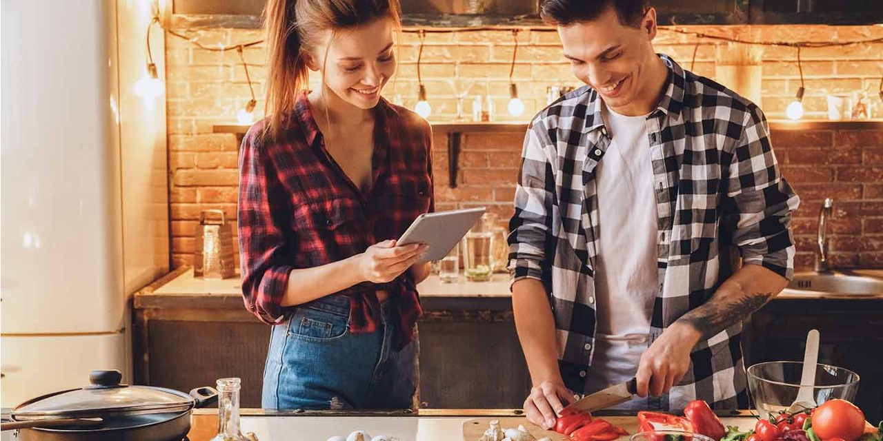 young couple cooking at home