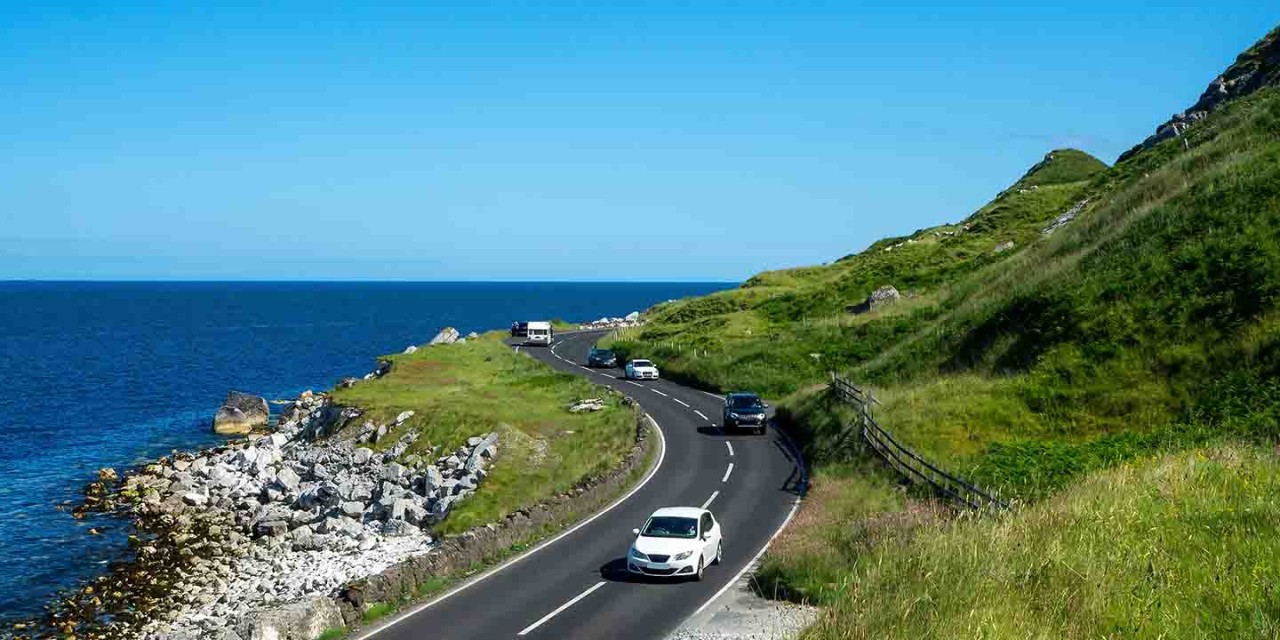  cars driving down a mountain road