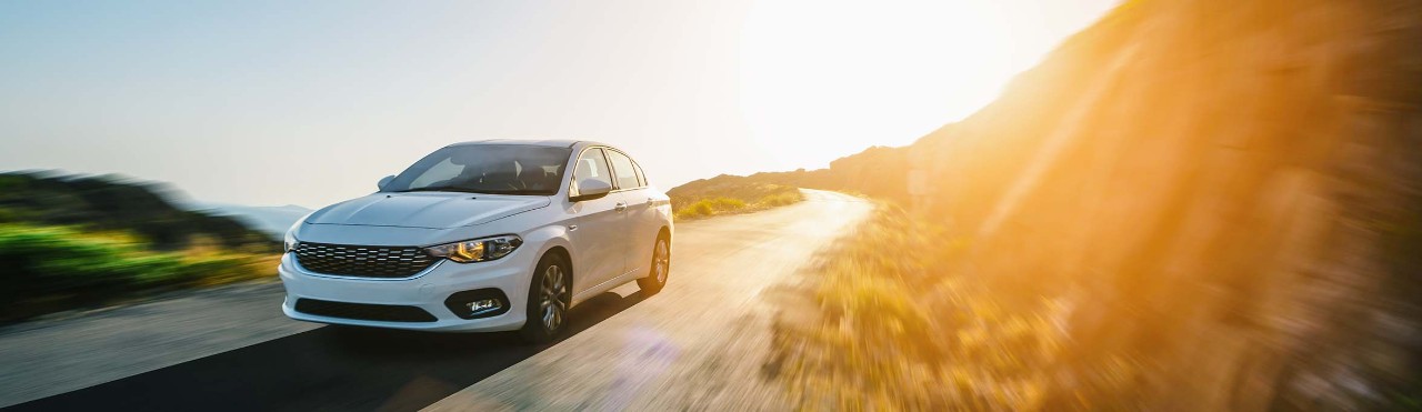 white car under the sunset