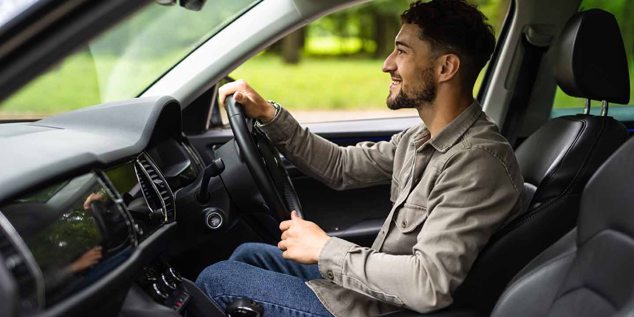  young man driving on car 