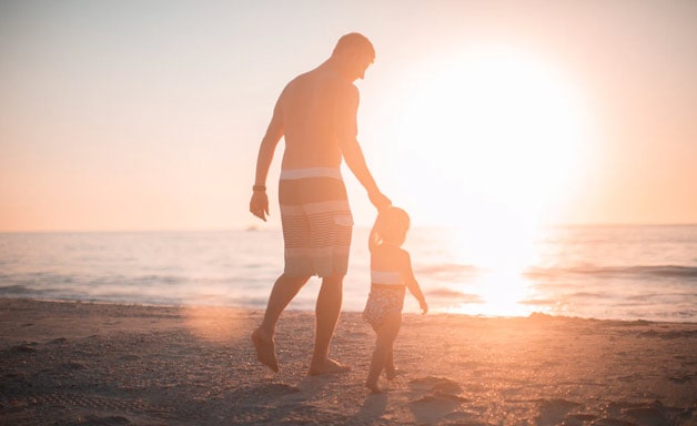 Son and dad on the beach sunshine