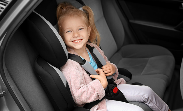 Child in Car Seat getting read for a long distance drive