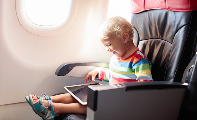 Child using tablet computer during flight