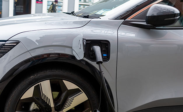 White electric car at charging station