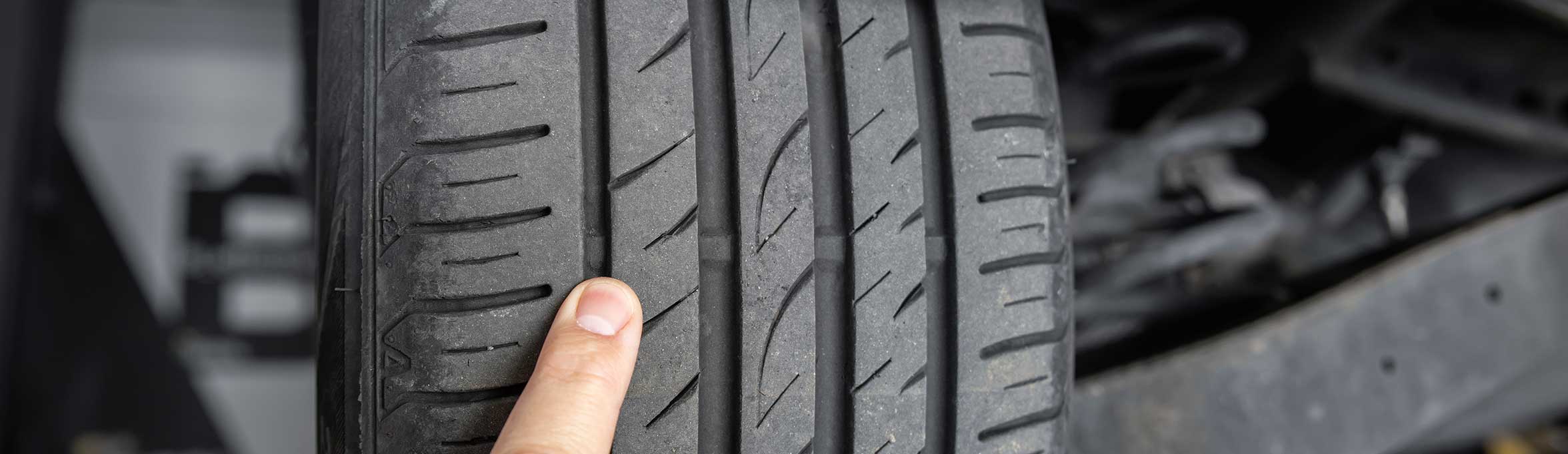  Finger showing tyre threads