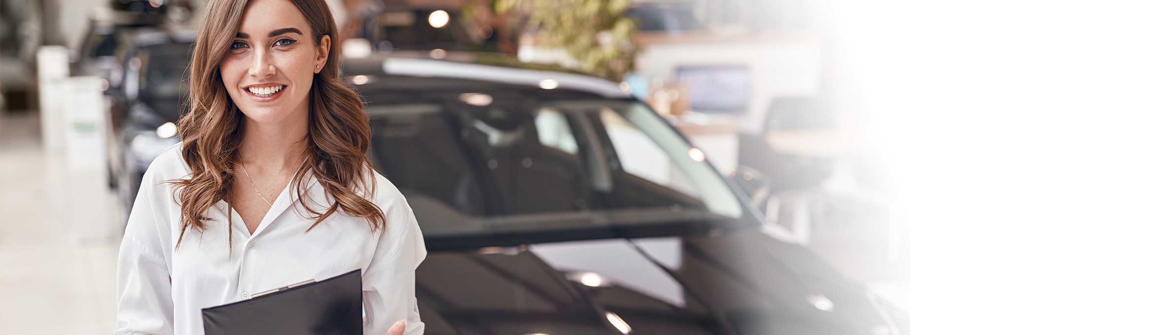  Woman with clipboard in front of a car